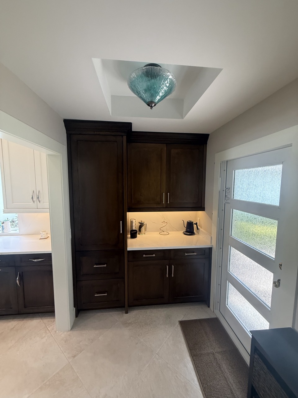 A custom cabinet coffee bar built in beside the entry.
