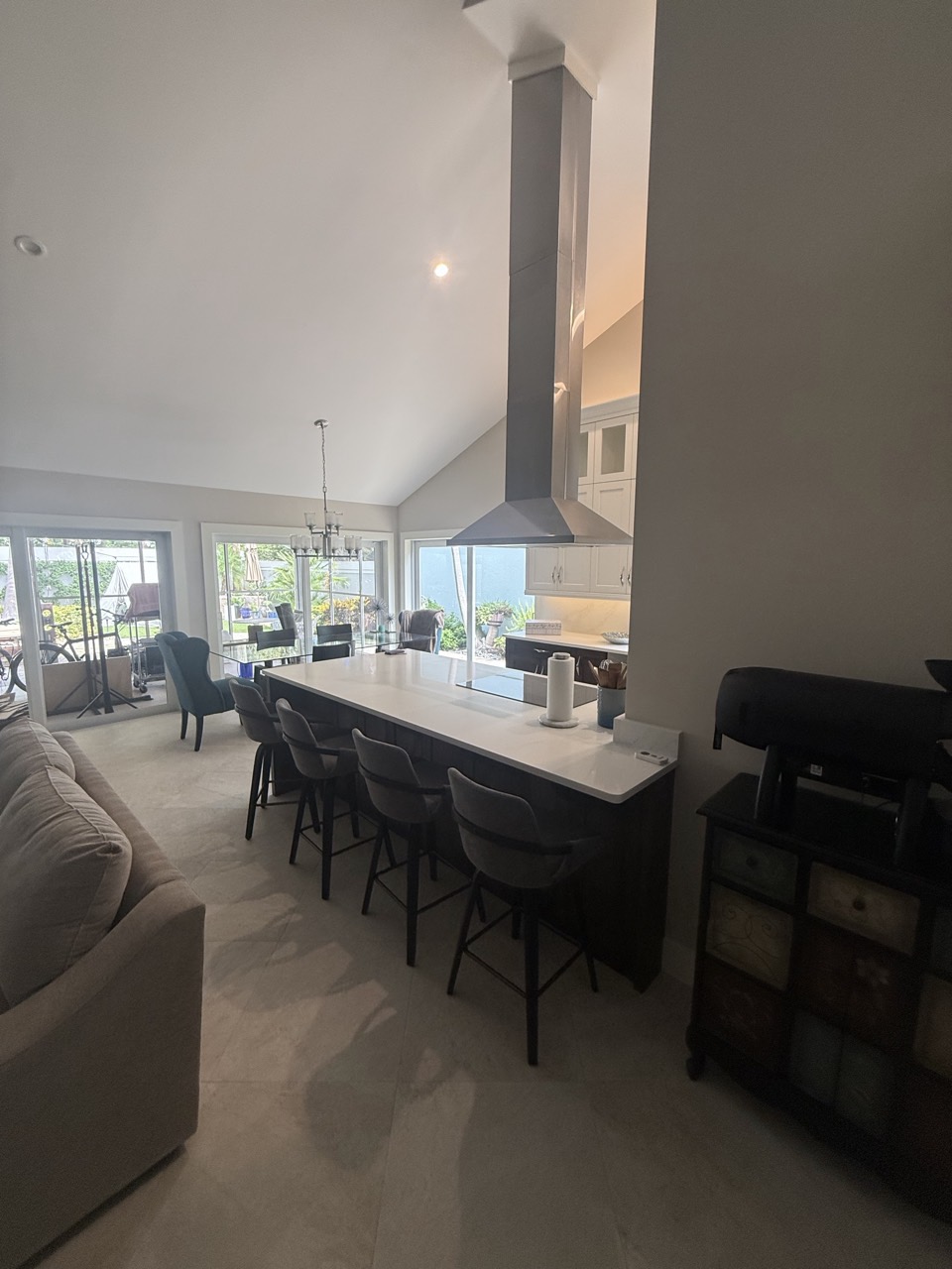 The new island and counter seating under the vaulted ceiling, with the range hood above.