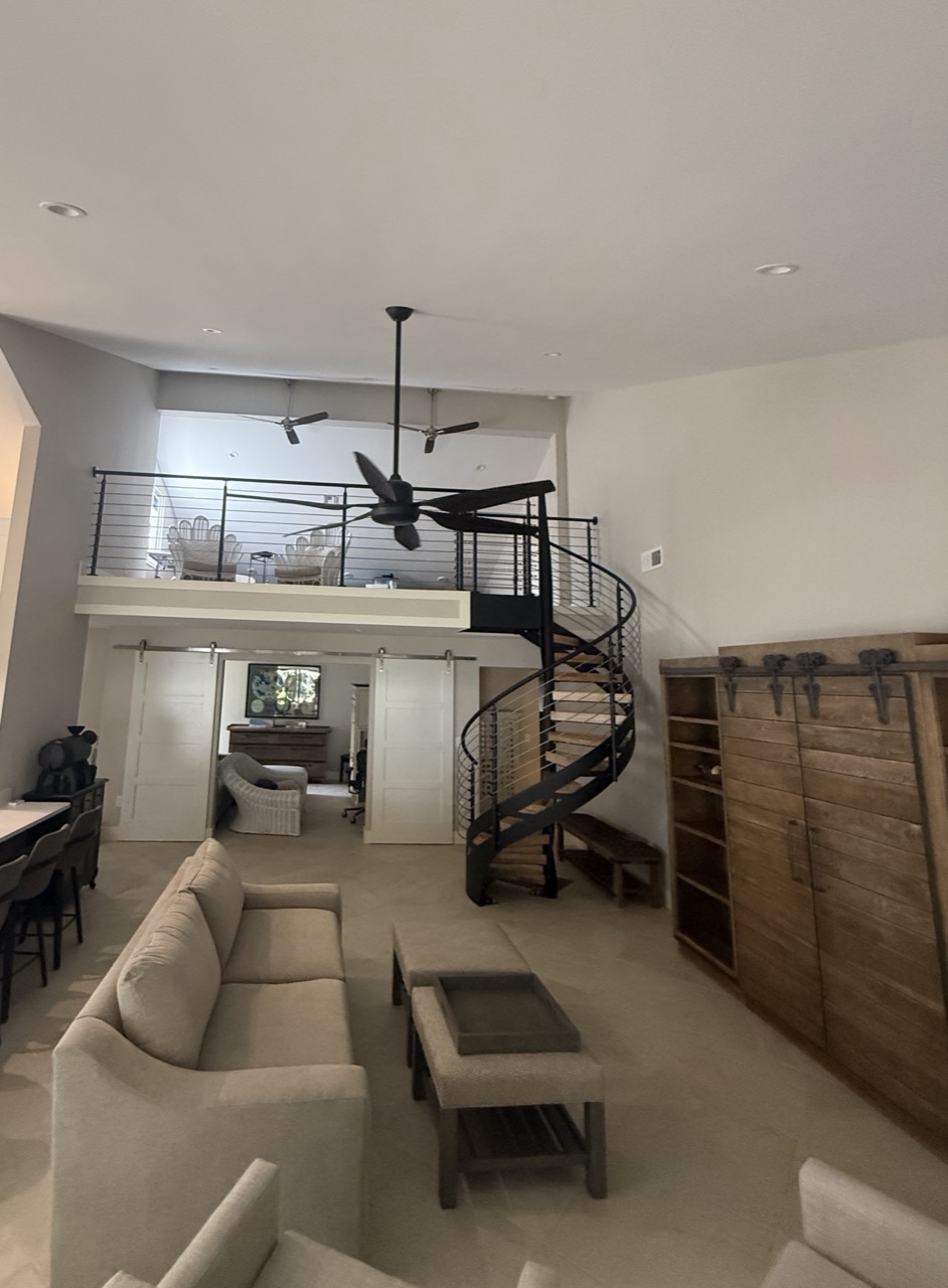 The custom spiral staircase up to the new loft office, built in what was previously vaulted ceiling space.