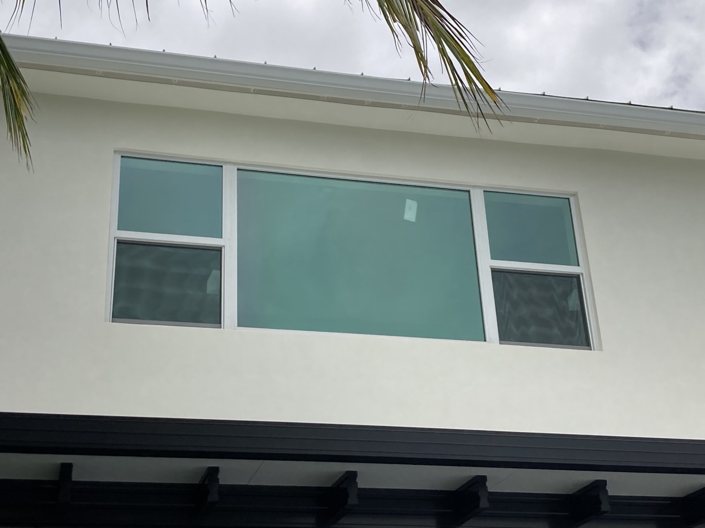 The finished exterior, with stucco and trim matching the rest of the house.