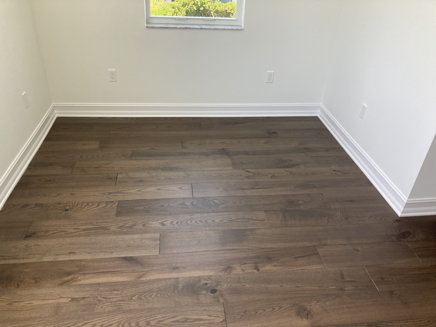 Engineered wood flooring and custom trim in the finished space.