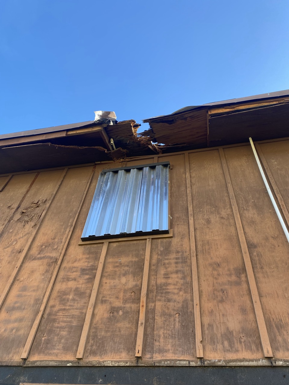 Storm damage to the roof edge and fascia, documented for the insurance claim.