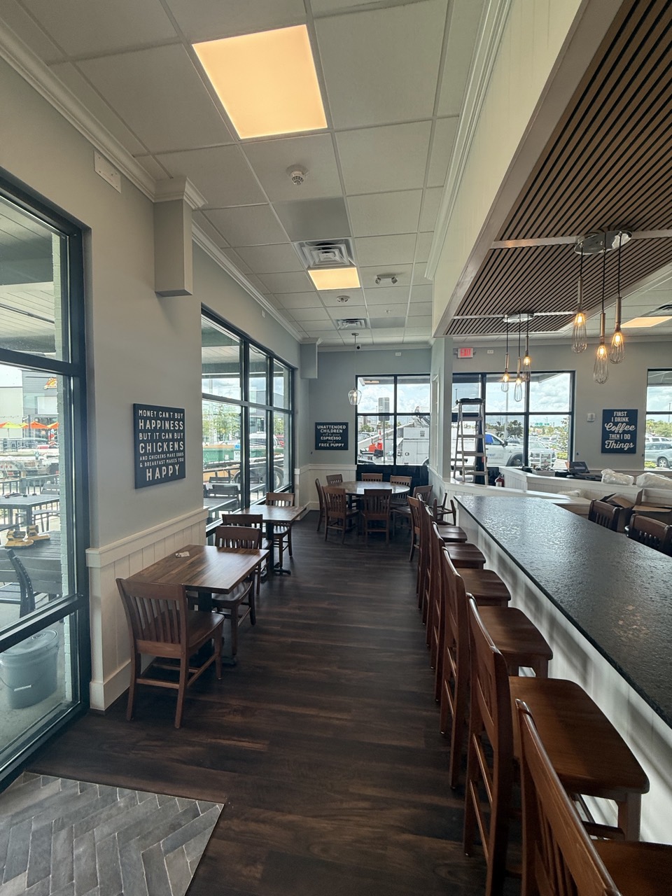 Counter seating along the window wall, with the slatted ceiling feature overhead.