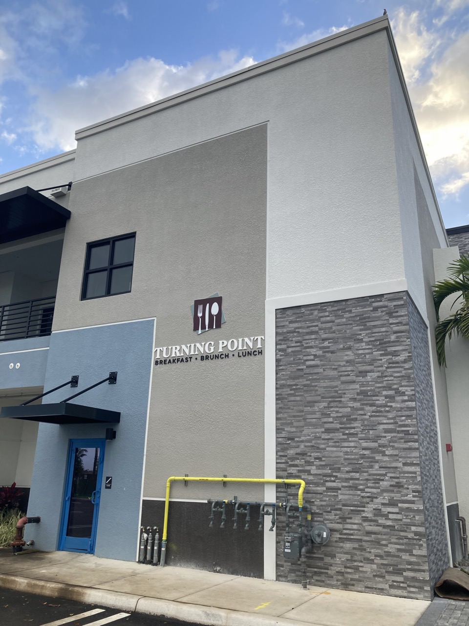 The finished exterior, with the entry and signage on the Lotus Plaza frontage.