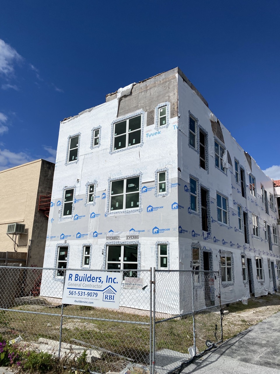 The building wrapped and re-windowed during construction, after the structural repairs.